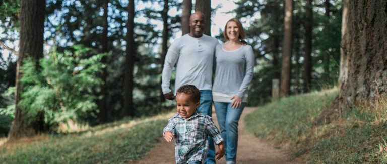 Image: family walking together, happy boy. Choose a new home in California or Nevada.