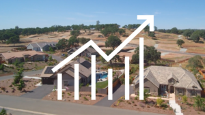 Icon of a home in the background behind a chart with three different lines indicating the fluctuating housing market and interest rates.