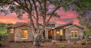 Outside of a beautiful new construction home by Tim Lewis Communities nestled in heritage oaks.