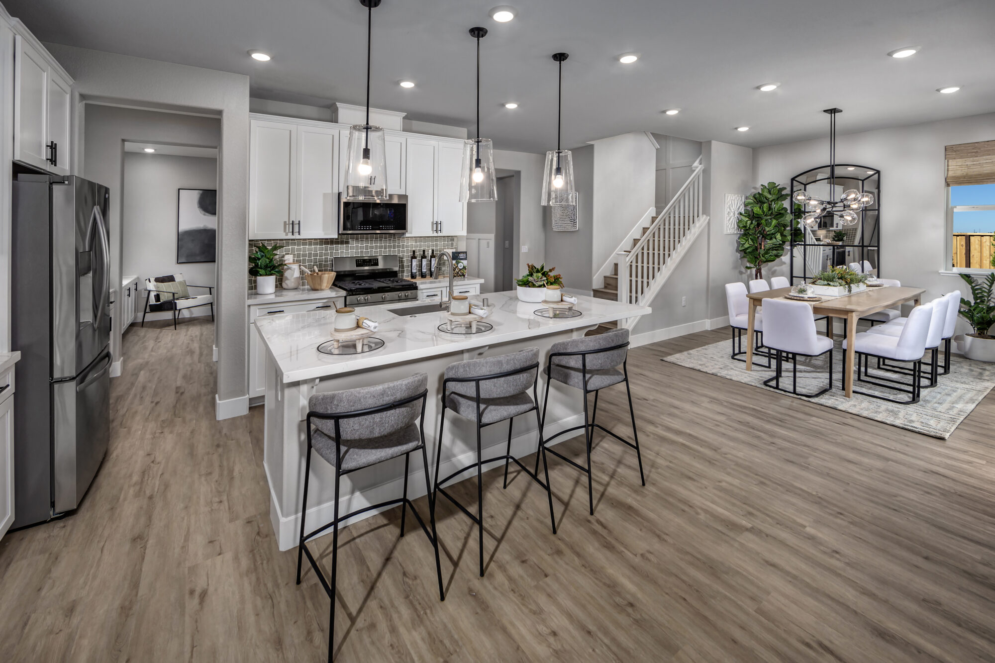 An open floorplan with a large island in the kitchen and dining room at The Oasis in Elk Grove, CA